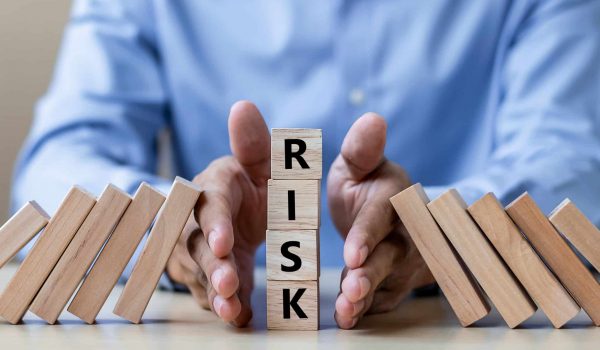 Businessman hand Stopping Falling wooden Blocks or Dominoes. Business, Risk Management, Solution, Insurance and strategy Concepts