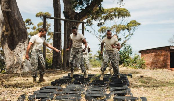 Trainer giving training to military soldiers at boot camp