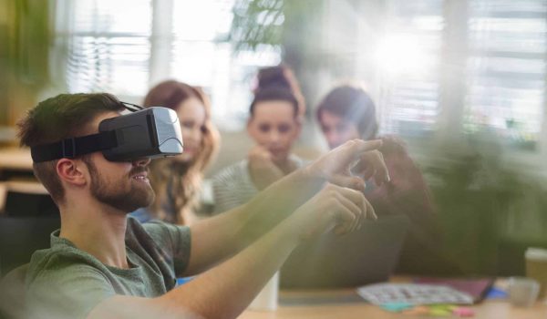 Male business executive using virtual reality headset in the office